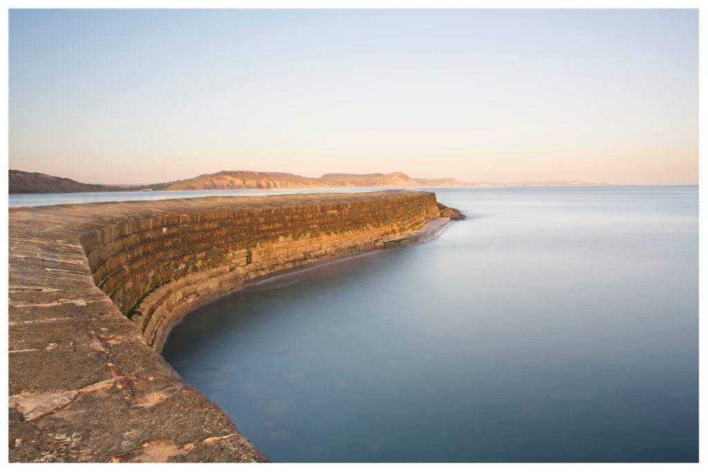 lyme regis the cobb harbour wall with jurassic coastline