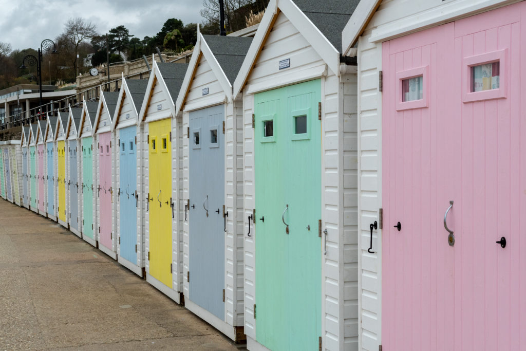 lyme regis colourful beach huts along beach front