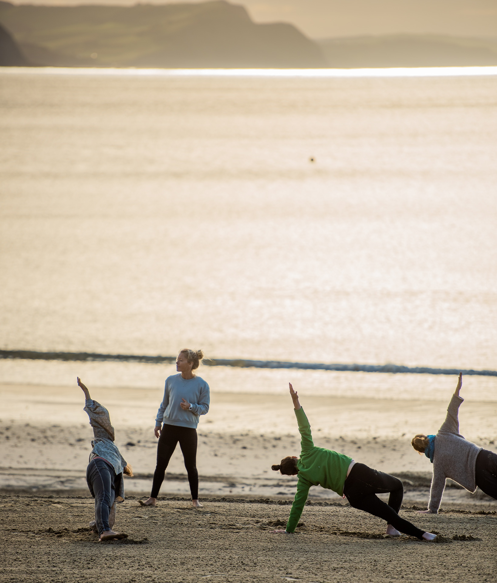 Lyme Regis group yoga class with morning sunrise