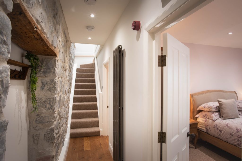 Self catered holiday cottage bedroom and hallway by Jurassic Properties in Lyme Regis