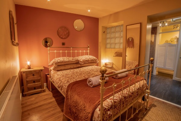 main bedroom with orange and cream interiors in dorset