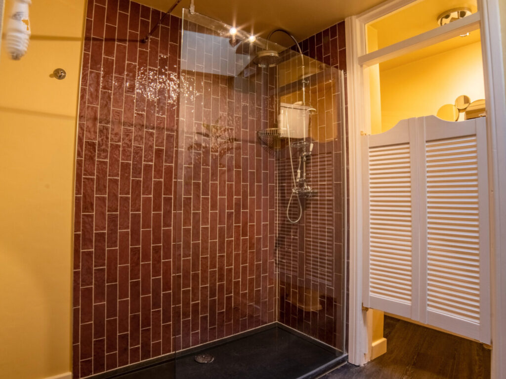 large showeroom with purple tiling